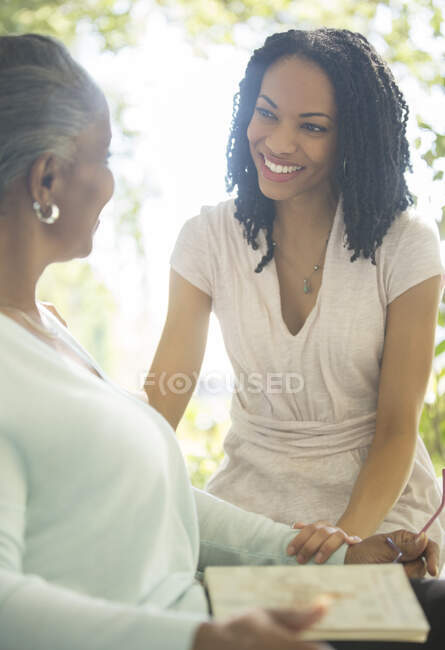 Happy mother and daughter talking outdoors — Stock Photo