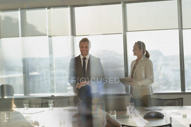 Smiling businessman leading conference room meeting — Stock Photo