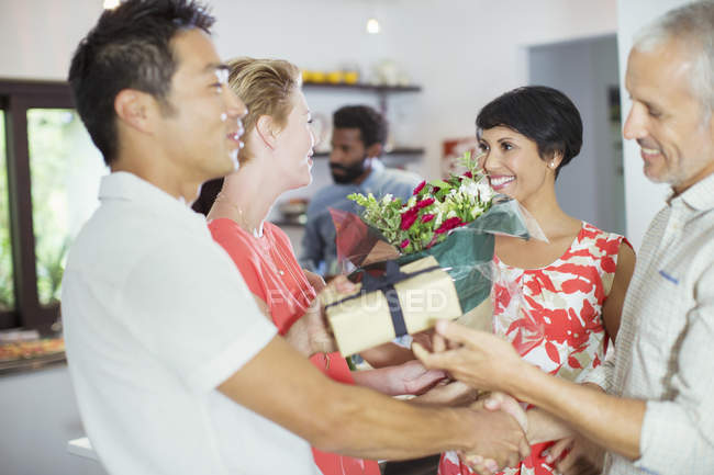 Couple exchanging gifts at party — Stock Photo