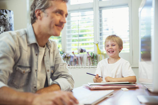 Father and son working in home office — Stock Photo