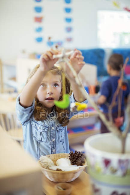 Student playing with model in classroom — Stock Photo