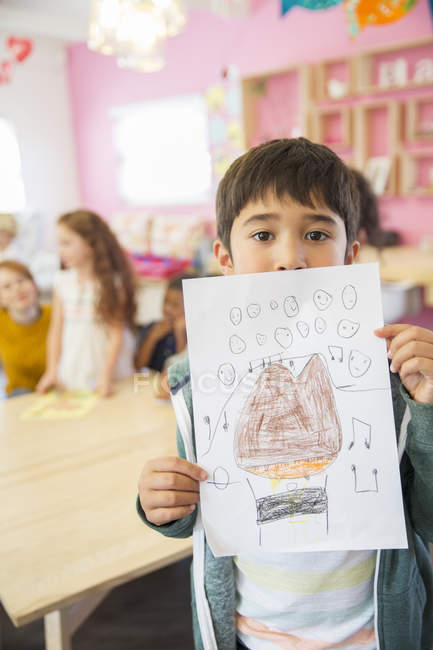 Student showing drawing in classroom — Stock Photo