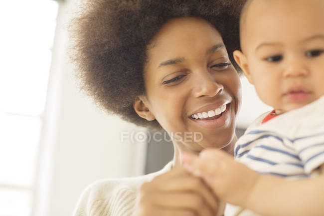 Mother holding baby boy at home — Stock Photo