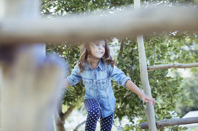 Girl climbing on play structure — Stock Photo