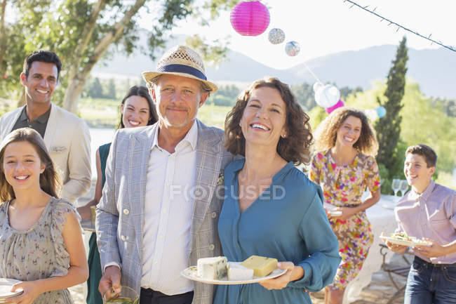 Older couple hugging at family picnic — Stock Photo