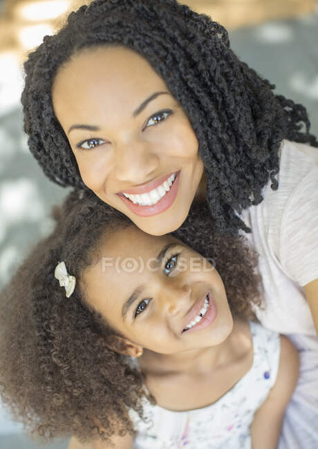Close up portrait of happy mother and daughter — Stock Photo