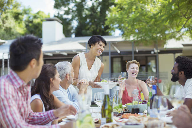Woman serving friends at party — Stock Photo