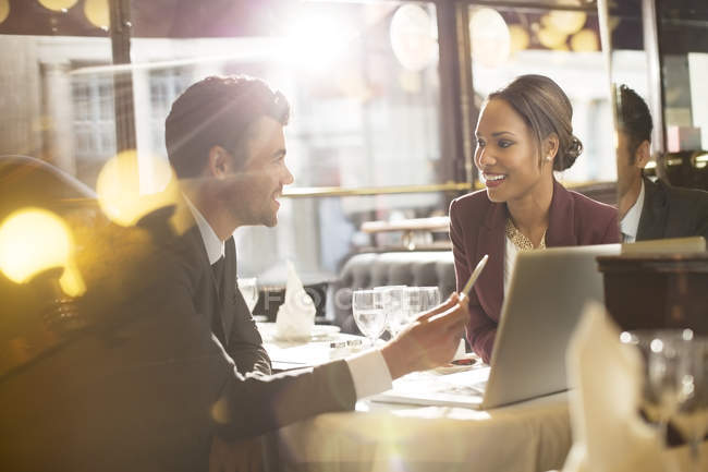 Young business people talking in restaurant — Stock Photo