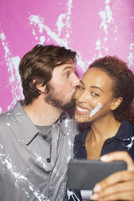 Couple playing and taking picture on cell phone — Stock Photo
