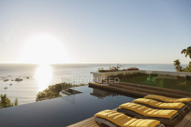View of sunset over ocean from luxury patio — Stock Photo