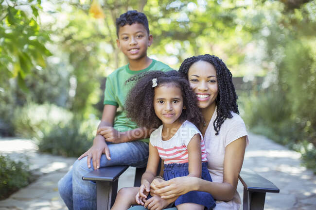 Portrait of smiling mother and children outdoors — Stock Photo