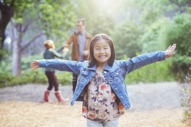 Girl cheering in forest  and smiling to camera — Stock Photo