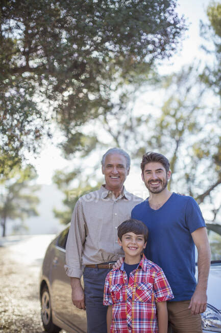 Portrait of multi-generation men outside car — Stock Photo