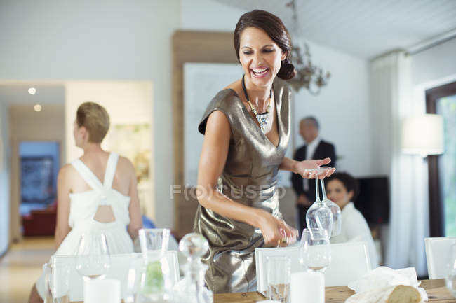 Woman setting table for party — Stock Photo