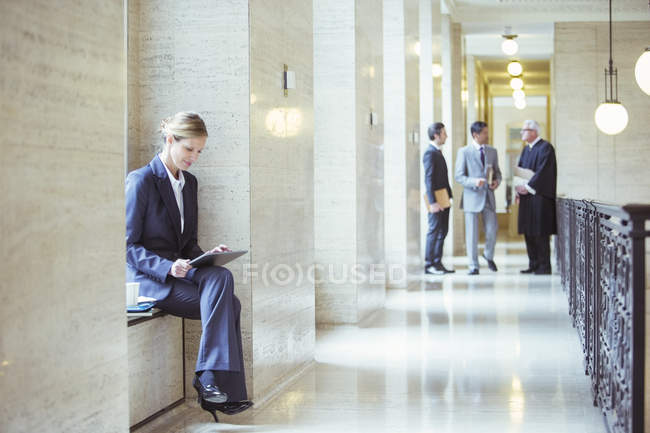 Lawyer working on digital tablet in courthouse — Stock Photo