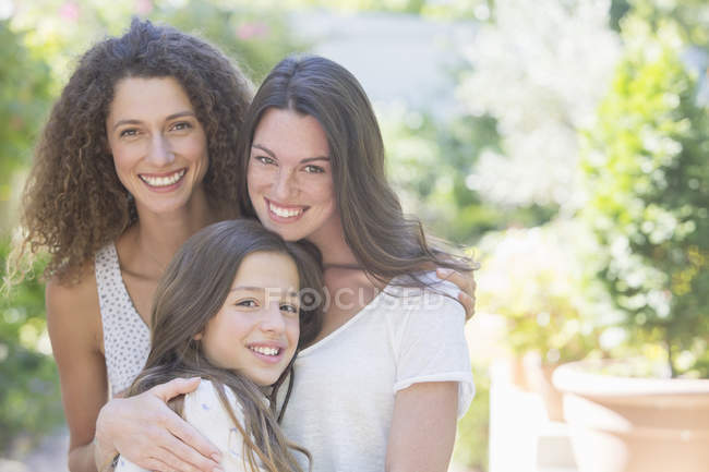 Happy beautiful sisters hugging outdoors — Stock Photo
