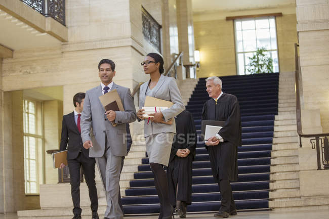 Judges and lawyer walking through courthouse — Stock Photo