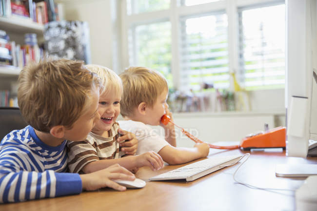 Дети вместе пользуются домашним офисом — стоковое фото