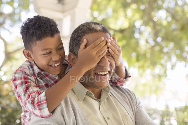 Grandson surprising grandfather on porch — Stock Photo