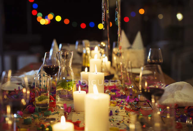 Lit candles on table at party — Stock Photo