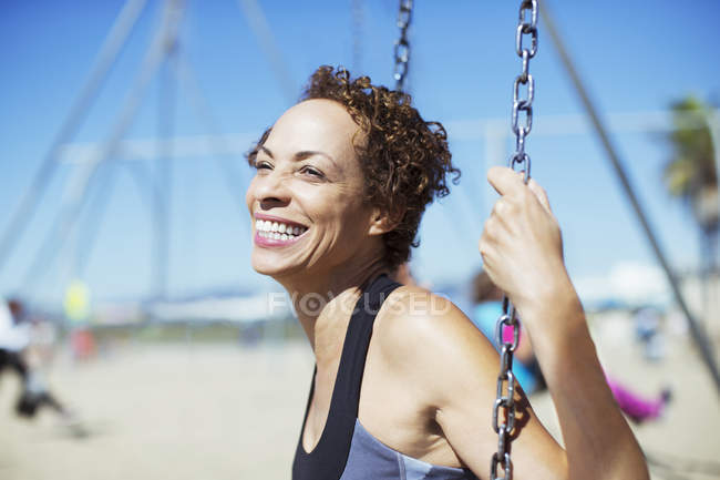 Happy enthusiastic black woman swinging — Stock Photo
