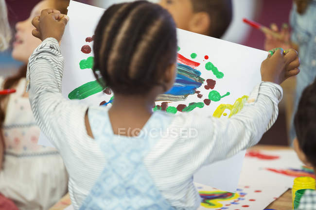 Student holding painting in class — Stock Photo