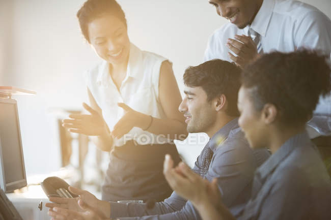 Business people cheering in office — Stock Photo