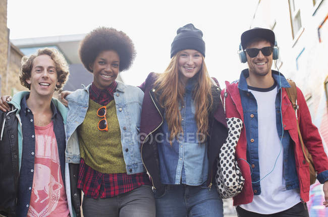 Friends walking together on city street — Stock Photo