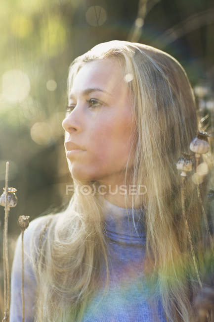 Pensive beautiful blonde teenage girl looking away outdoors — Stock Photo