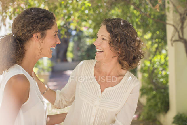 Happy beautiful mother and daughter laughing together — Stock Photo