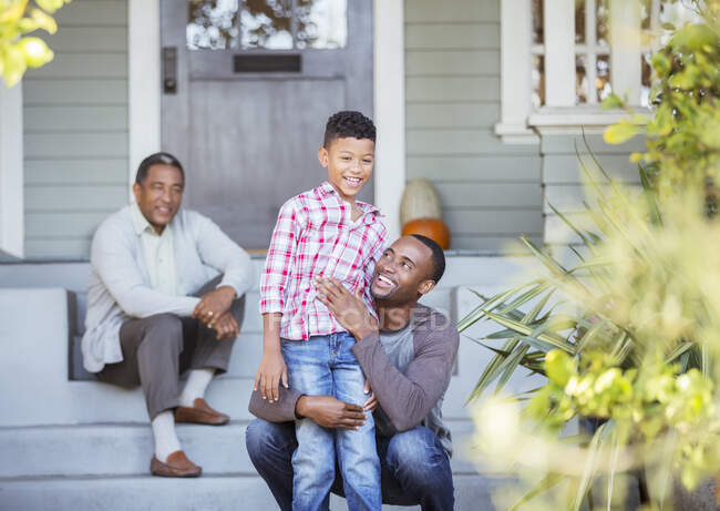 Multi-generation men on porch steps — Stock Photo