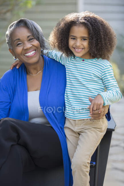 Portrait of happy grandmother and granddaughter outdoors — Stock Photo