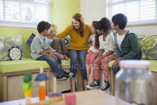 Students and teacher talking in classroom — Stock Photo