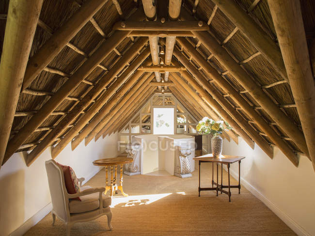 Sunny luxury attic under wooden roof — Stock Photo