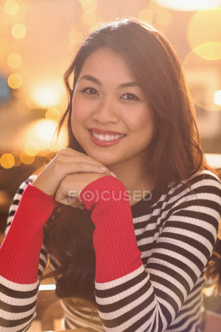 Portrait smiling Chinese woman wearing striped sweater — Stock Photo