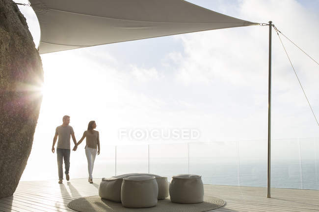 Пара держащихся за руки на современном балконе — стоковое фото