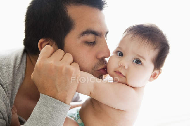 Father kissing adorable baby girl — Stock Photo