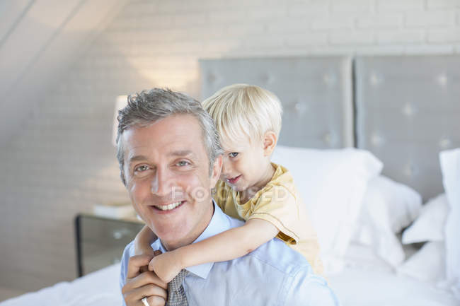 Father carrying son piggyback — Stock Photo