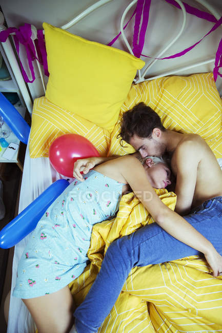 Jeune couple dormant au lit après une dure fête — Photo de stock