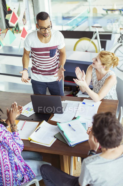 People applauding colleague in office — Stock Photo