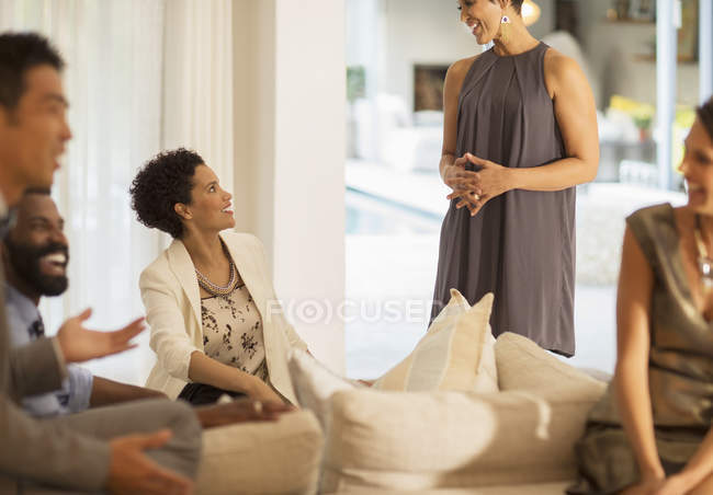 Friends talking at party indoors — Stock Photo