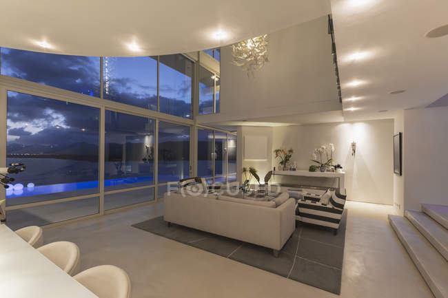 Illuminated modern luxury home showcase interior at night — Stock Photo