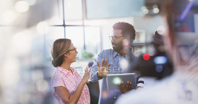 Business people with digital tablet talking and planning in office — Stock Photo