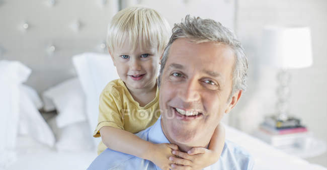 Father and son hugging on bed — Stock Photo