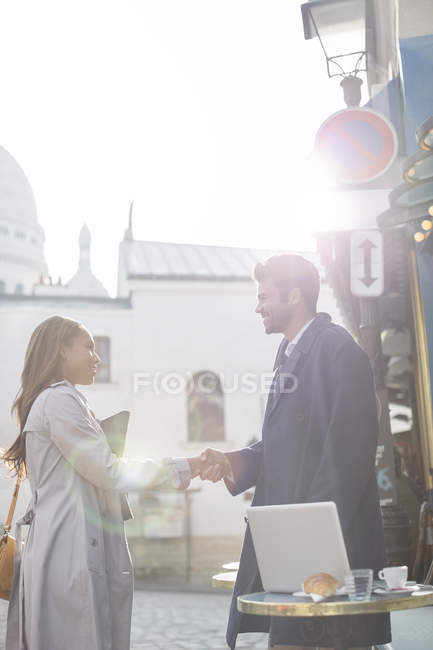 Business people shaking hands at sidewalk cafe, Paris, France — Stock Photo