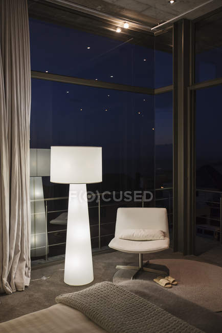 Lamp and chair in corner of modern bedroom — Stock Photo