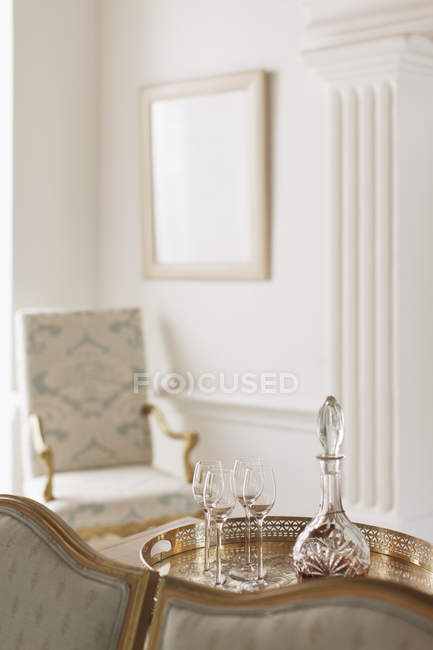 Crystal sherry decanter and cordial glasses in luxury living room — Stock Photo