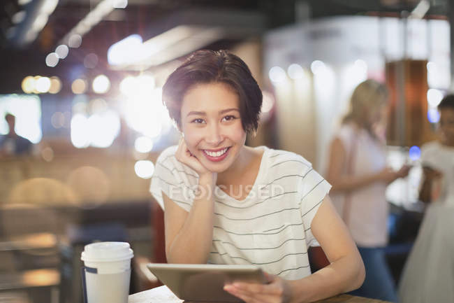 Retrato sorrindo jovem mulher usando tablet digital e beber café no café — Fotografia de Stock
