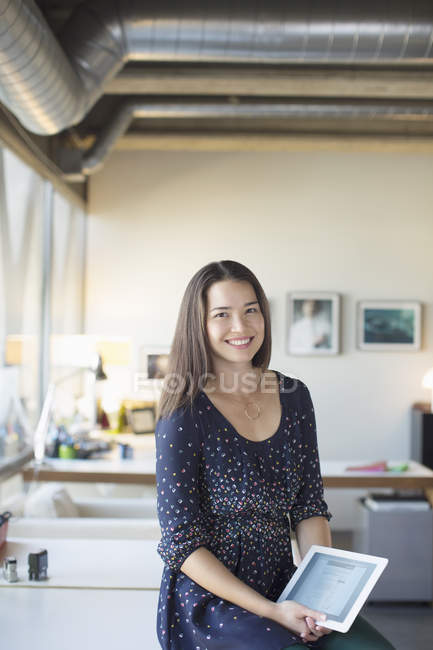 Portrait of smiling businesswoman with digital tablet in office — Stock Photo