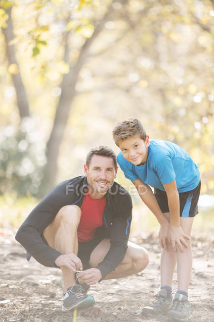 Portrait father and son preparing for hike in woods — Stock Photo